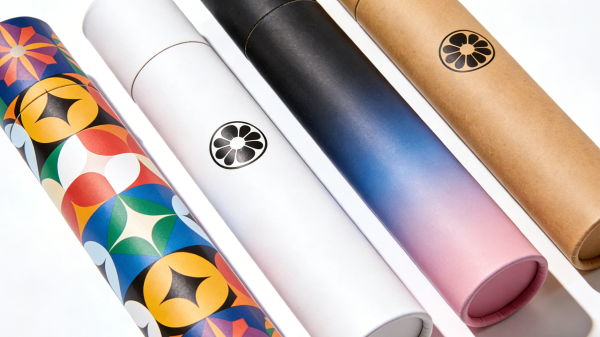 Assorted custom printed paper tubes with different graphics, colors, and branding designs displayed upright