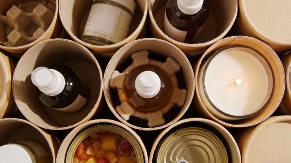 Close-up of custom rigid box with gold foil stamping, embossing, textured paper, and spot UV finish