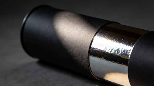 Paper tube packaging with spot UV gloss contrast on matte surface