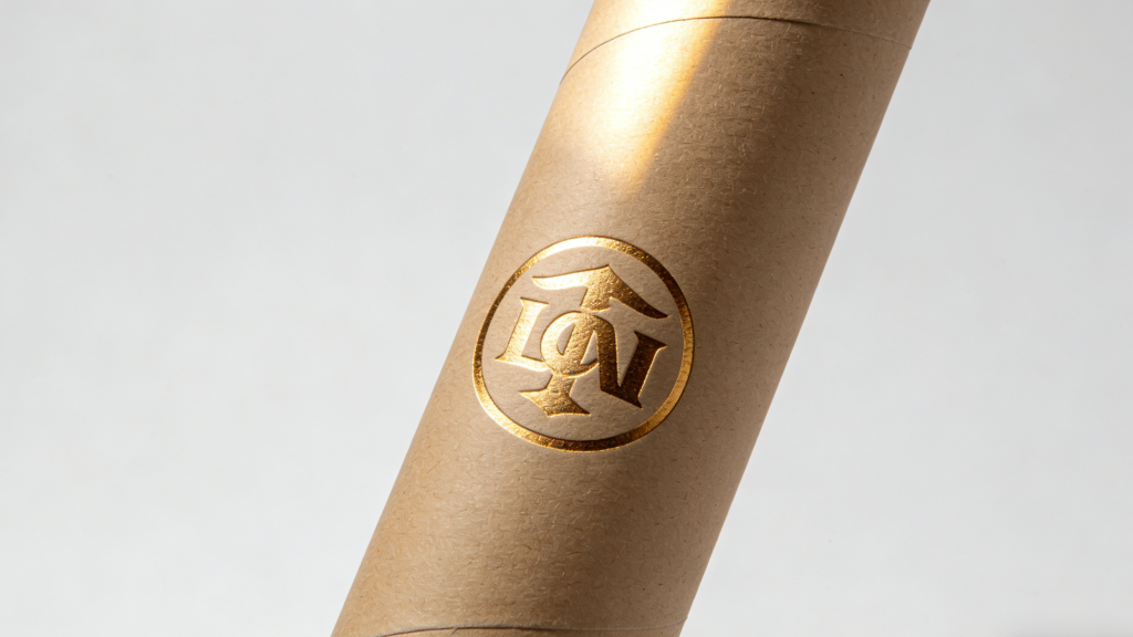Cosmetic paper tube with gold foil logo and embossed texture detail